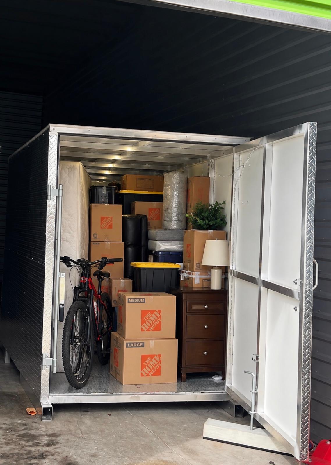 Actual SPS storage container with boxes, shelving and a bicycle inside